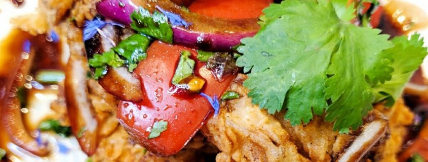 Colorful dish with vegetables and cilantro garnish.