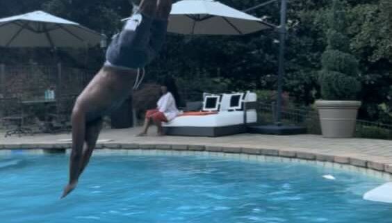 Man diving into a swimming pool.