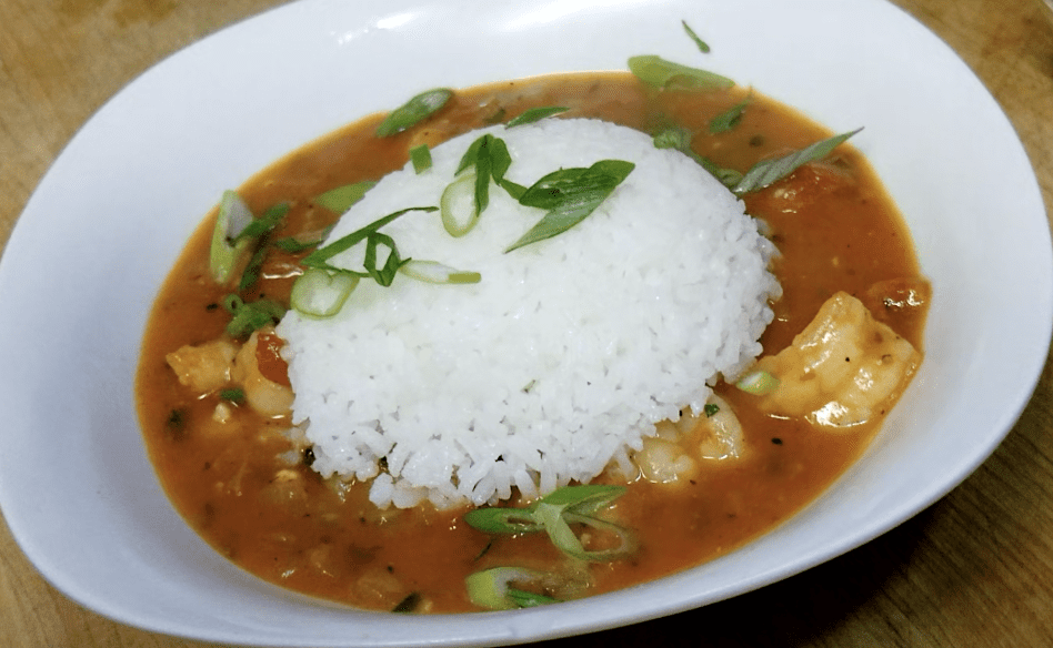 White rice with spicy curry and garnish.