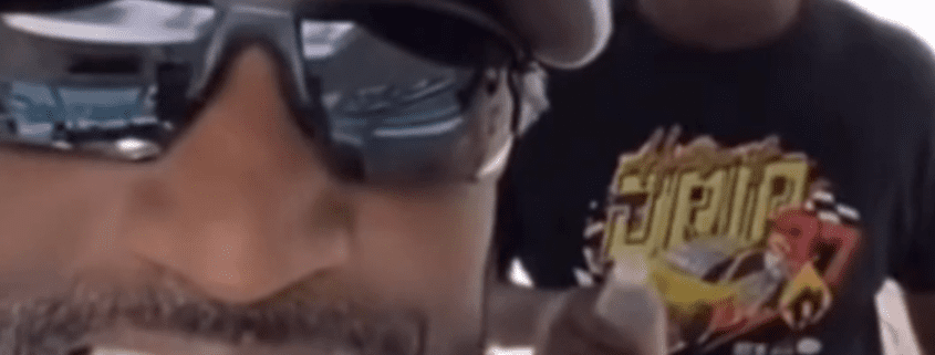 Two people, one wearing sunglasses, smiling.