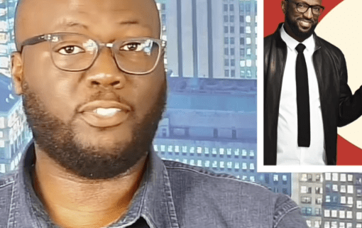 Man in glasses with city background.