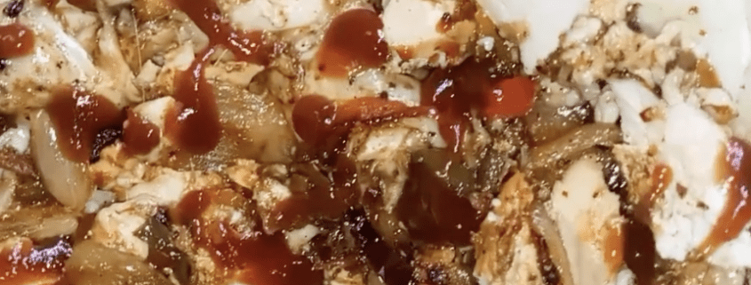 Grilled chicken with sauce and onions.