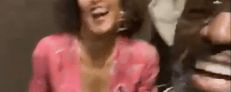 Two people laughing and smiling together.