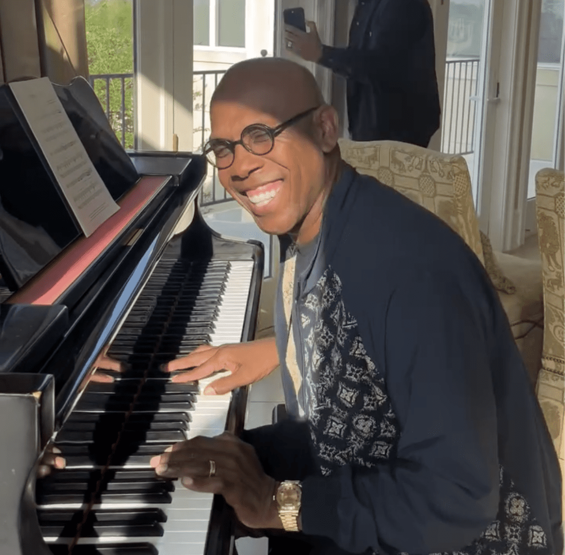 Joseph Walker III 2025 Man smiling while playing the piano indoors.